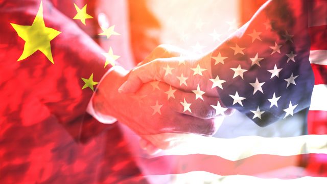 Businessman-shake-hand-over-United-States-of-America-and-China-flag-UNAMGlobal